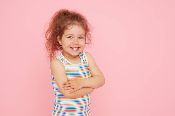 Portrait of cute little child girl with a snow-white smile and healthy teeth over pink background. looking at the camera and laughing. Dentistry for children - Fotoğraf, Görsel