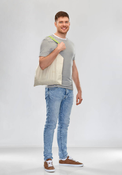 man with reusable canvas bag for food shopping - Фото, изображение
