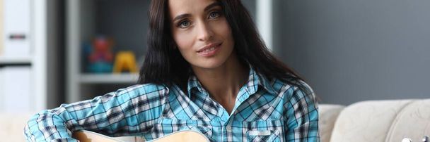 Beautiful girl with acoustic guitar in her hands - Zdjęcie, obraz