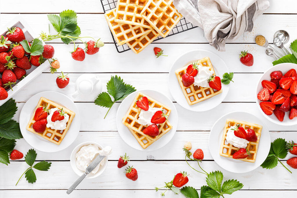 Traditional belgian waffles with cream cheese and fresh strawberry on white background - Zdjęcie, obraz