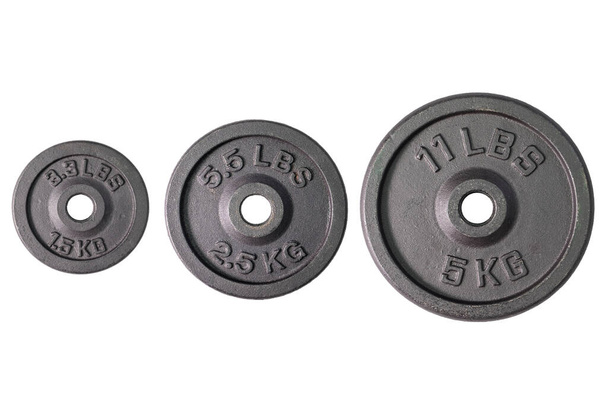 Weight for sport isolated on white background. Gym equipment 1.5, 2.5, 5 kilograms. Black metal barbell tool plate for exercise and fitness. Three dumbbell heavy concept. - Φωτογραφία, εικόνα