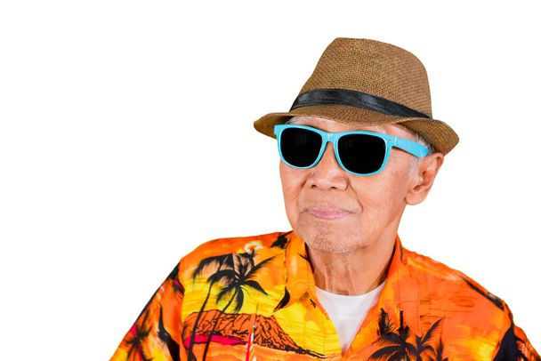 Close up of old male model wearing sunglasses and summer clothes in the studio, isolated on white background - Foto, Imagem