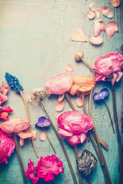 Pretty flowers retro pastel toned on vintage turquoise background, top view - Photo, Image