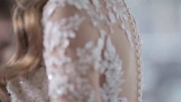 bride in wedding dress shoulders covered with embroidery - Footage, Video