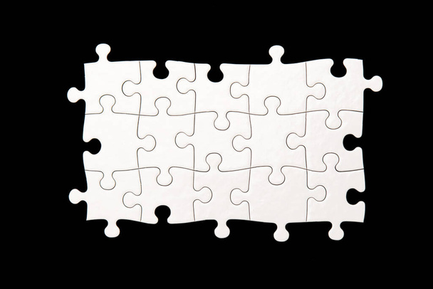White puzzle on a black background - Foto, imagen