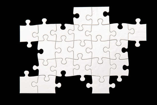 Puzzle bianco su sfondo nero - Foto, immagini