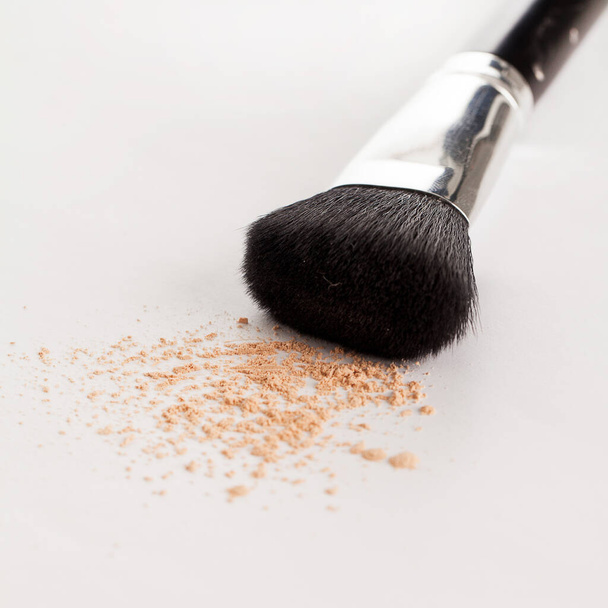 Makeup natural brush with beige powder on a white background - Photo, Image