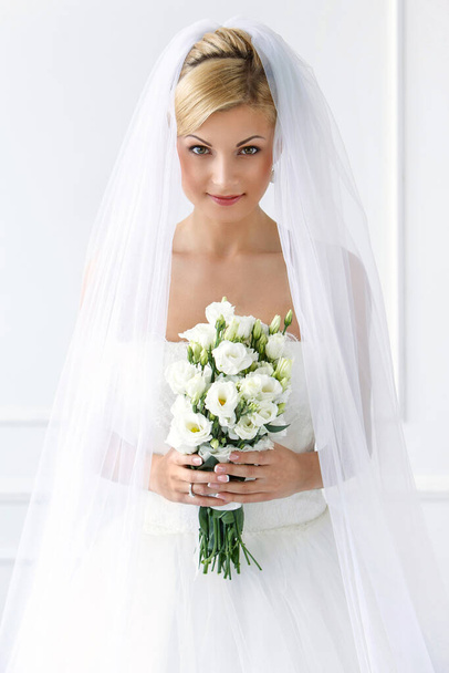 Wedding. Attractive bride with beautiful bouquet - Фото, изображение