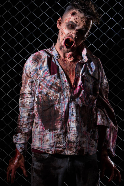 Creepy zombie on the fence background - Φωτογραφία, εικόνα