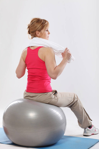 Portrait of an attractive woman exercising in studio - Fotó, kép