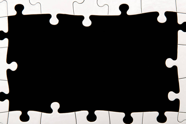 White puzzle on a black background - Foto, Imagem