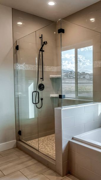 Cabina de ducha rectangular vertical con mampara de vidrio medio y cabezal de ducha negro
 - Foto, imagen