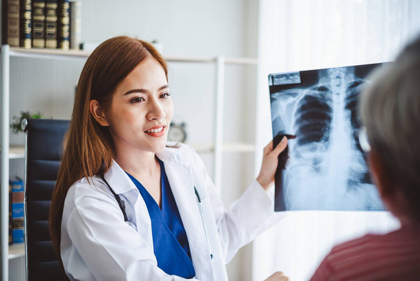 médicos asiáticos muestran diagnosticar paciente radiografía radiografía película a viejo paciente, asiático médico concepto - Foto, imagen