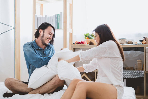 Young Asian couple lover having fun  tickling together, laughing smile in bedroom, Asian couple lifestyle on Valentine's day - Photo, Image