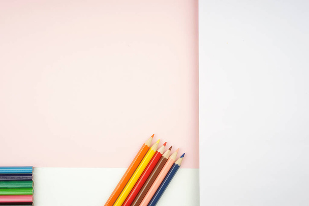Back To School concept. Flat lay view of stationeries such as pen, pencils, watercolors and others creatively arranged on light background. - Foto, imagen