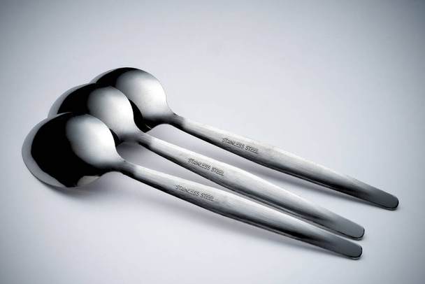 Creative arrangement of kitchen silverware, fork and spoon. Abstract and conceptual. - Fotografie, Obrázek