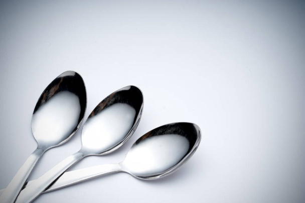 Creative arrangement of kitchen silverware, fork and spoon. Abstract and conceptual. - Photo, Image
