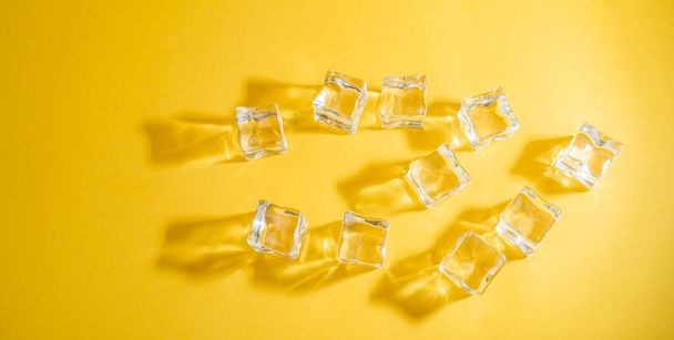 close-up view of frozen ice cubes on yellow background - Foto, imagen