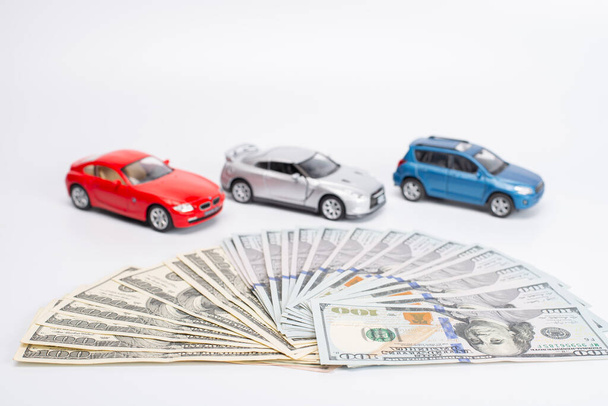 dollar banknotes with toy cars on white background - Photo, Image