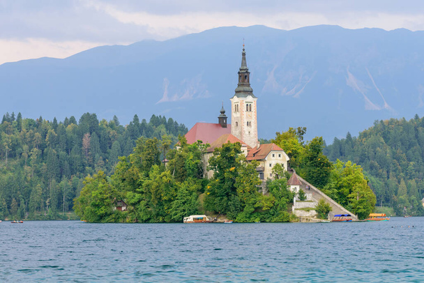 Lake Bled with St. Marys Church of Assumption on small island. Bled, Slovenia, Europe. Mountains and valley on background.  - Photo, Image