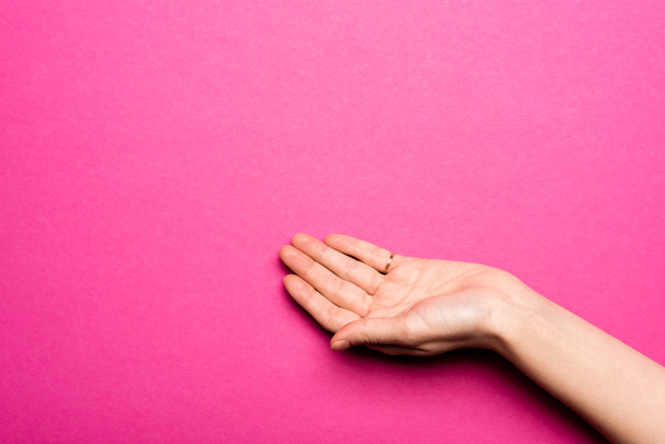 female hand with open palm on pink - 写真・画像