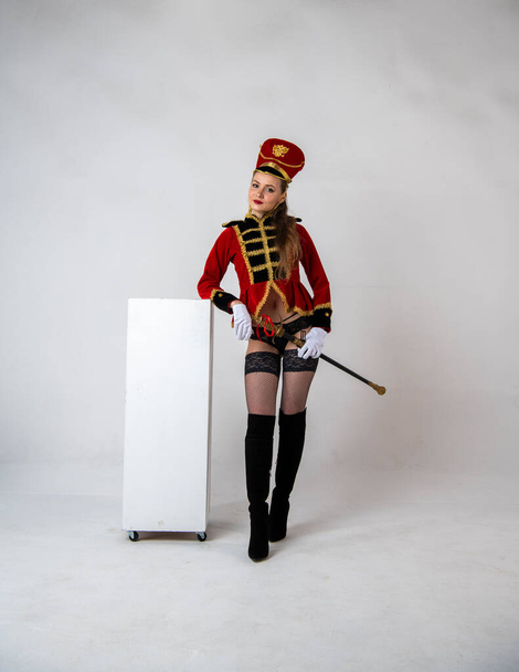 beautiful girl in a red hussar costume with a sword - Foto, imagen