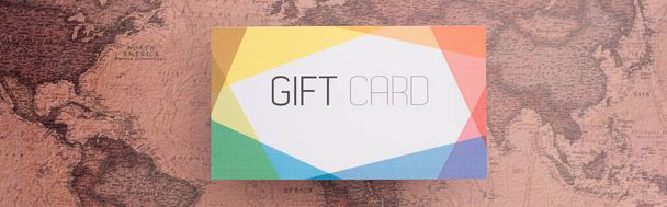Panoramic orientation of colorful gift card on map surface - Foto, imagen