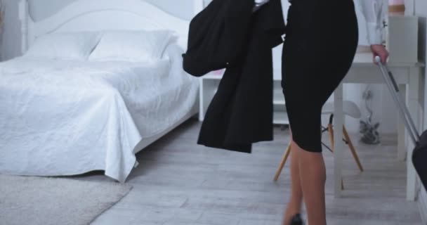Woman walking in to a hotel room with suitcase and fell on bed tired. After a long flight business woman arrived and checked in. Business concept. Prores 422 - Felvétel, videó
