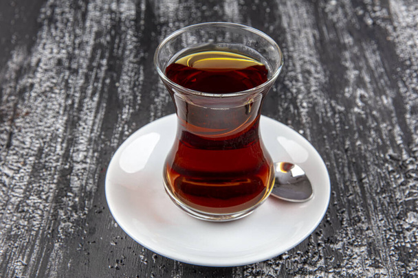 Traditional Turkish tea. Turkish Tea on famous glass on wooden table.  - Photo, Image