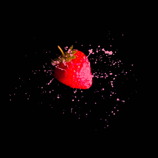 Strawberry in cream splash on black background - Fotó, kép