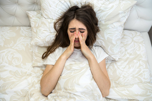 sick attractive girl lying in  bed with taking a medicine. coronavirus. - Фото, изображение