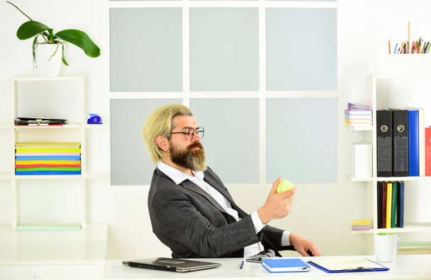 man hold tennis ball while working in office. take a break. handsome businessman play tennis. Sport and business. concept of success and achievement. Office games during a working break - 写真・画像