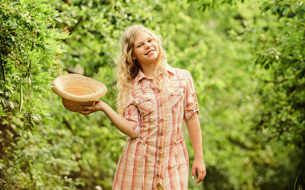 Ranch girl. Child smiling girl beautiful long curly hair nature background. Natural care. Adorable girl outdoors. Cosmetics concept. Happy childhood. Walk fresh air. Good mood. Summer vacation - Photo, image