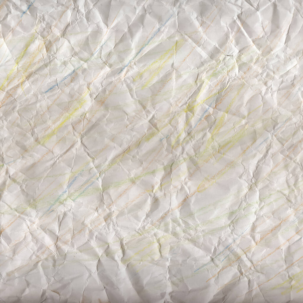 Verfrommeld vel wit papier met stroken veelkleurige potloden. Gekromde papieren textuur. Abstracte achtergrond. - Foto, afbeelding