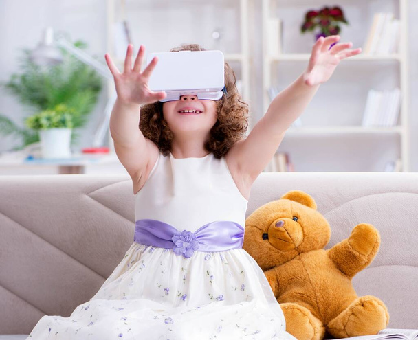 Young little girl with VR virtual reality glasses - Photo, Image
