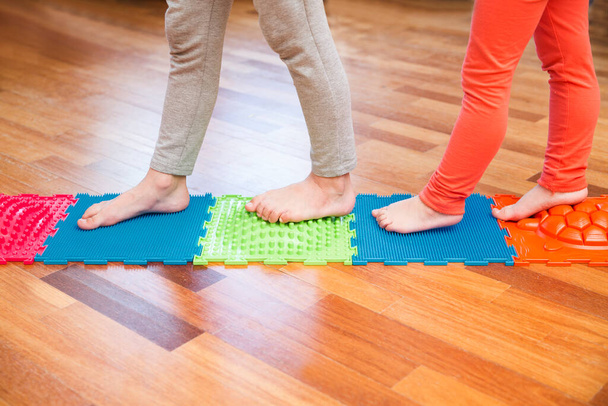 Kids  foots on an massaging mat. prevention flat feet and hallux valgus. - Foto, immagini