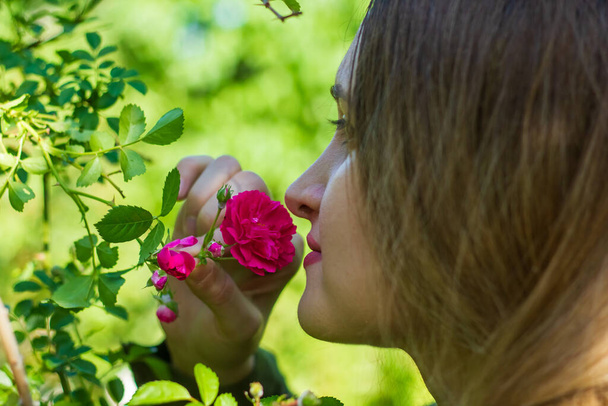joven mujer oliendo una flor, mujer en el jardín
 - Foto, imagen