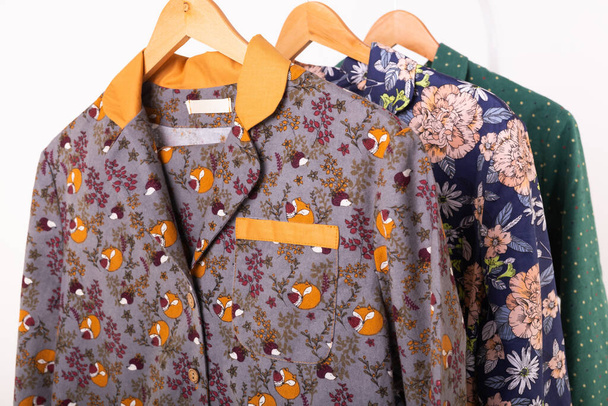 Kleding detailhandel concept. Dames pyjama op hangers in kledingwinkel close-up. Een pyjama in de winkel. Reclame, verkoop, mode en shopping concept. - Foto, afbeelding