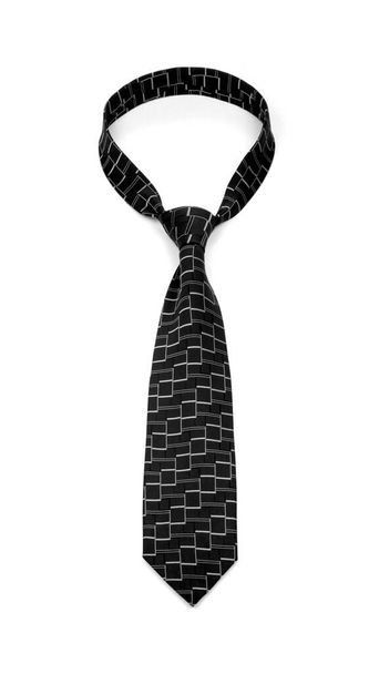 Stylish tied black tie with abstract silver pattern isolated on white background - Photo, Image