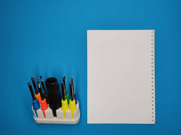 A set of multi-colored screwdrivers on a blue background. Copy space. - Фото, зображення