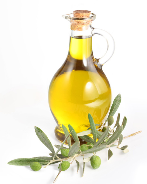 Branch with olives and a bottle of olive oil isolated on white - Foto, imagen