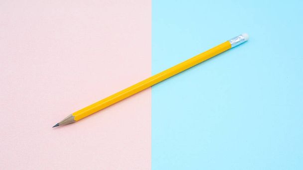 ピンクと青の紙の上の黄色の鉛筆-背景 - 写真・画像