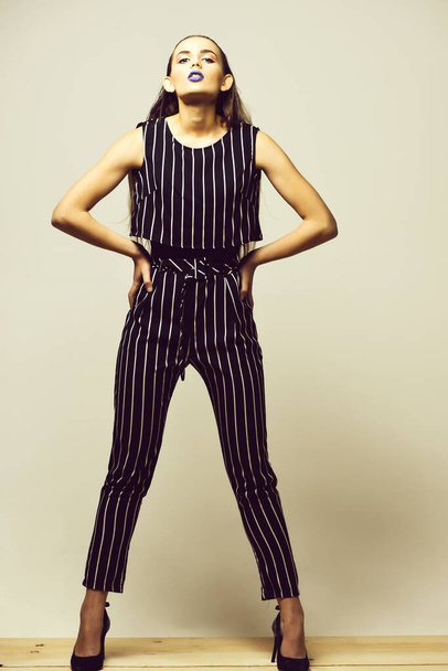 Pretty girl in striped suit - Фото, изображение