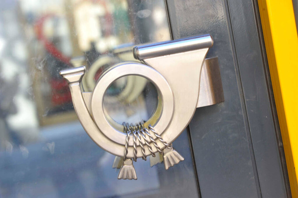 graphical symbol of a post horn on a door handle - Photo, Image