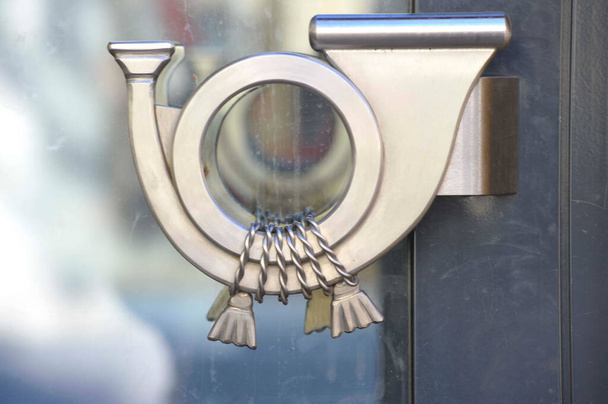 graphical symbol of a post horn on a door handle - Photo, Image