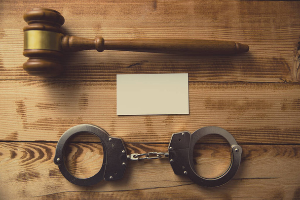 Judge Gavel with Handcuff and Paper on tabl - Фото, зображення