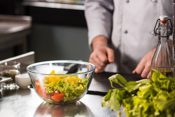 Mutfak masasında sağlıklı taze salata. Cam kasede karışık sebzeler.. - Fotoğraf, Görsel
