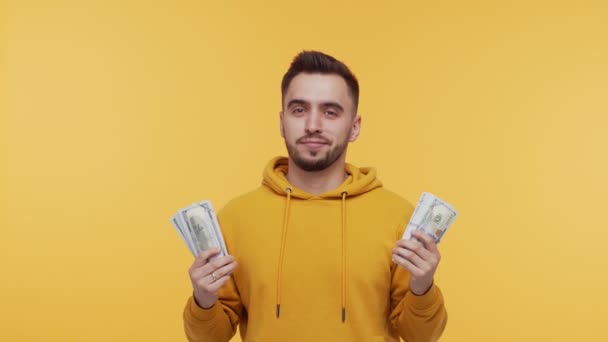 Expressive and happy young man with a bunch of money. Person who won jackpot. Lottery and casino concepts. - Metraje, vídeo