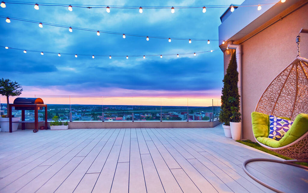 rooftop deck patio area with hanging chair on a sunset - Foto, Imagen