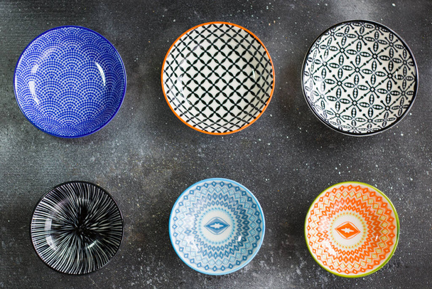 Colorful empty bowls on the black background, Geometry texture. - Photo, Image
